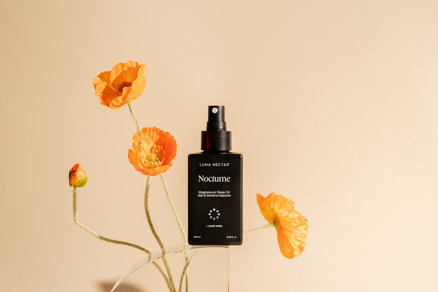 Nocturne Magnesium Sleep Oil bottle with orange flowers, natural sleep aid for relaxation and better sleep