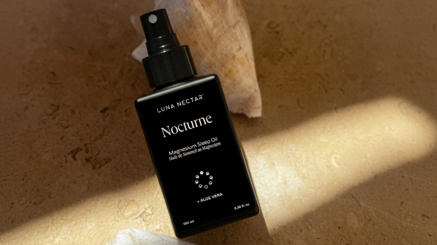 Nocturne Magnesium Sleep Oil bottle on brown background with natural shells, magnesium oil spray for sleep and nighttime relaxation