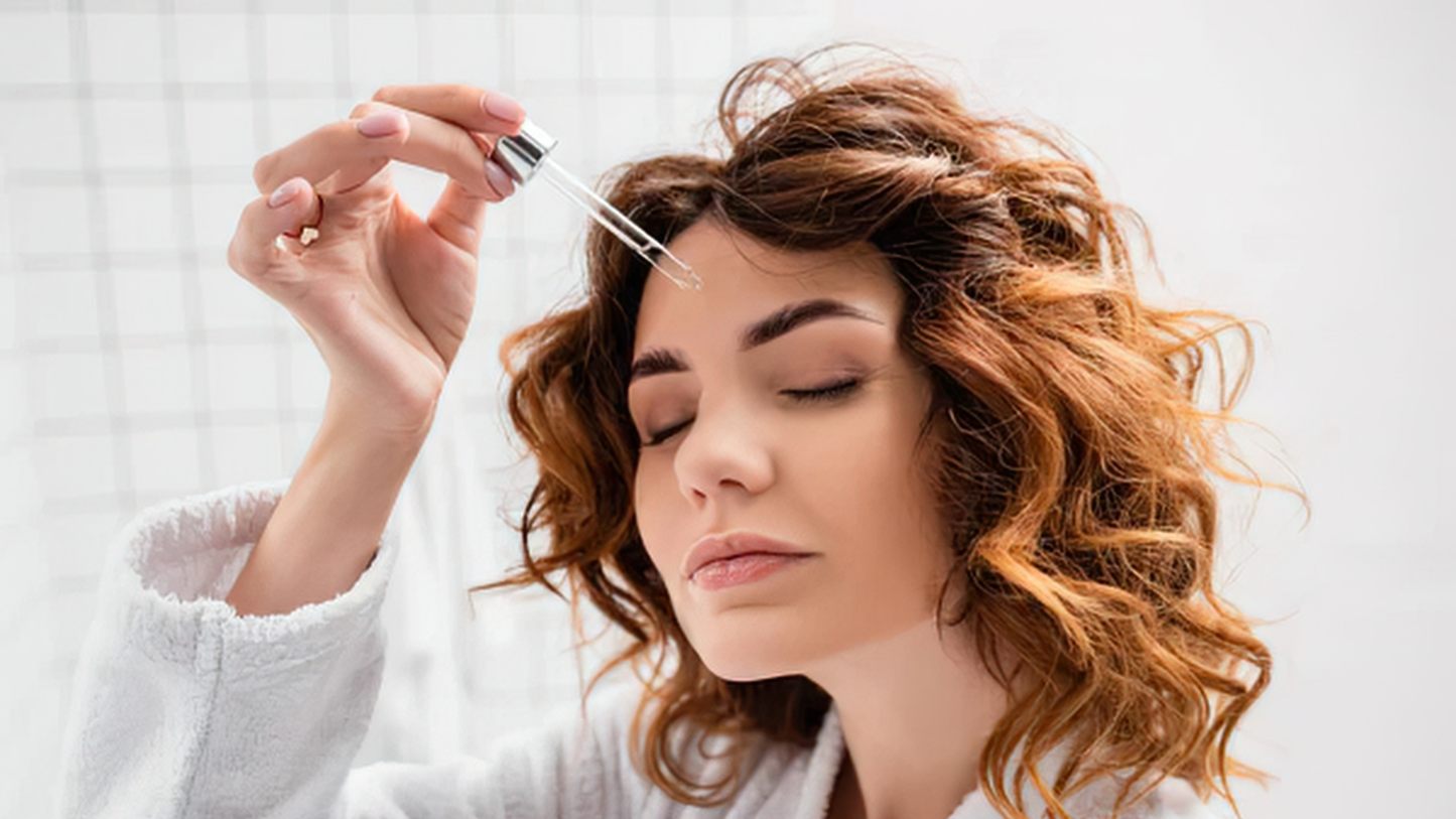 applying scalp serum with adaptogens to support hair density and scalp health
