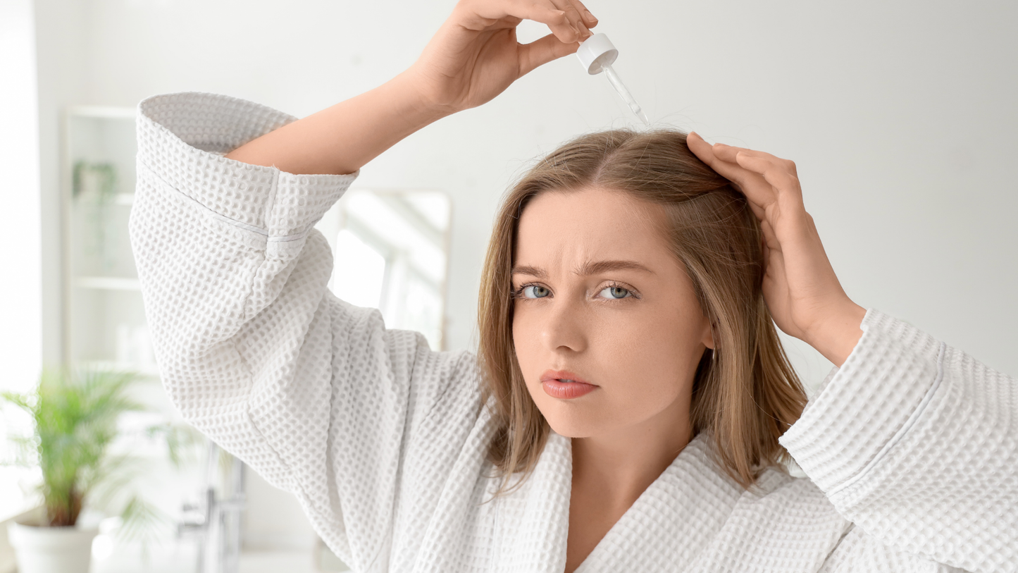 Applying scalp serum directly to the scalp as part of a daily scalp serum routine.